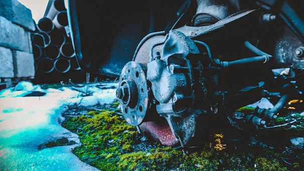 Close-up of a mechanic inspecting a car brake rotor outdoors.