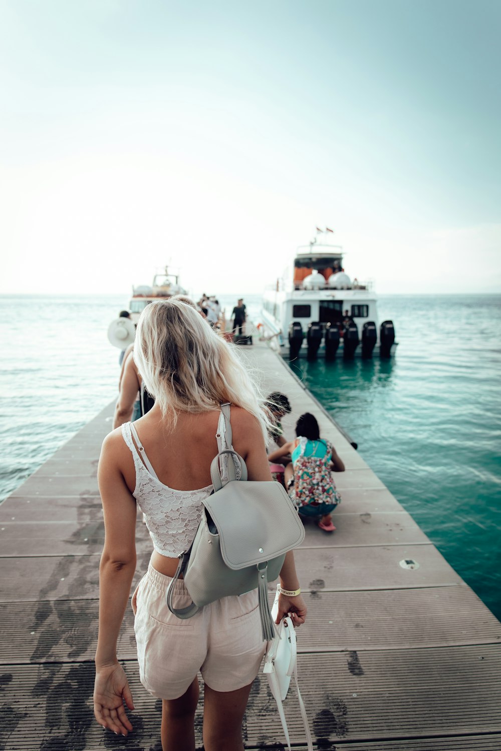 woman walking on dock going on boat
