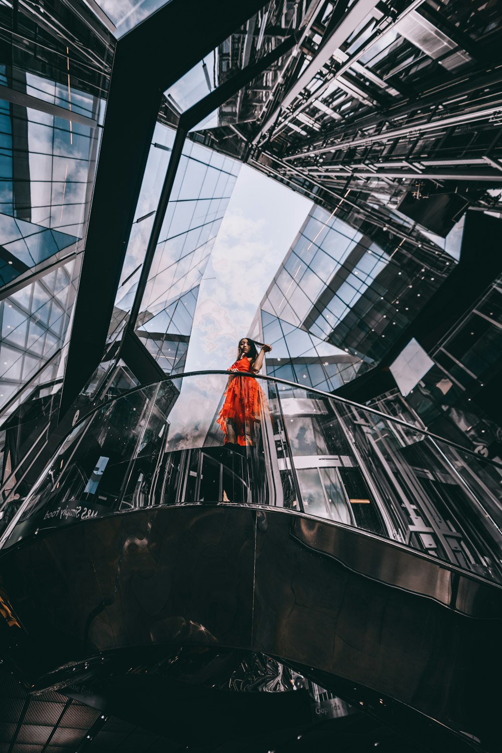 woman in and orange dress on a gray building