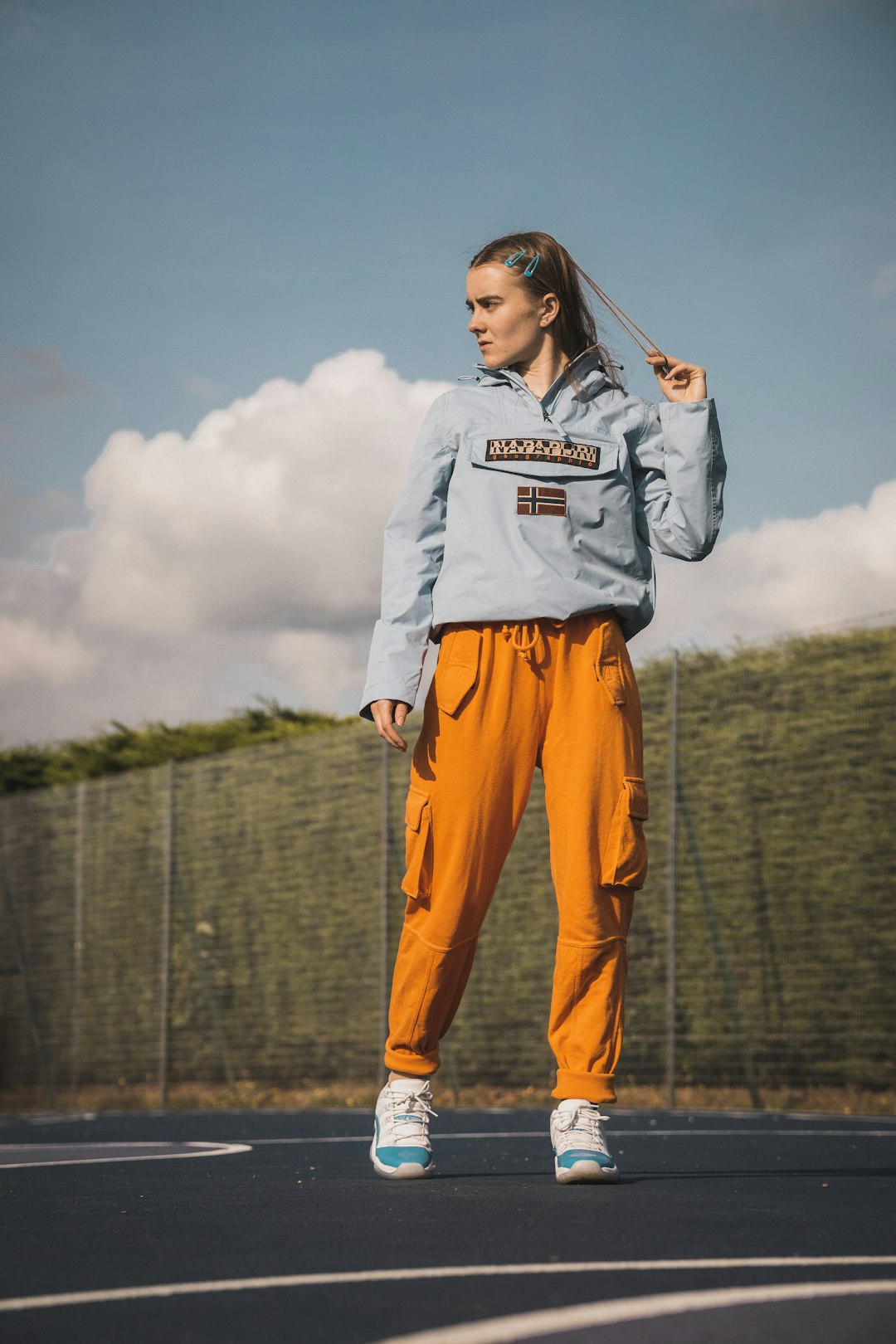 woman wearing blue pullover hoodie and orange pants