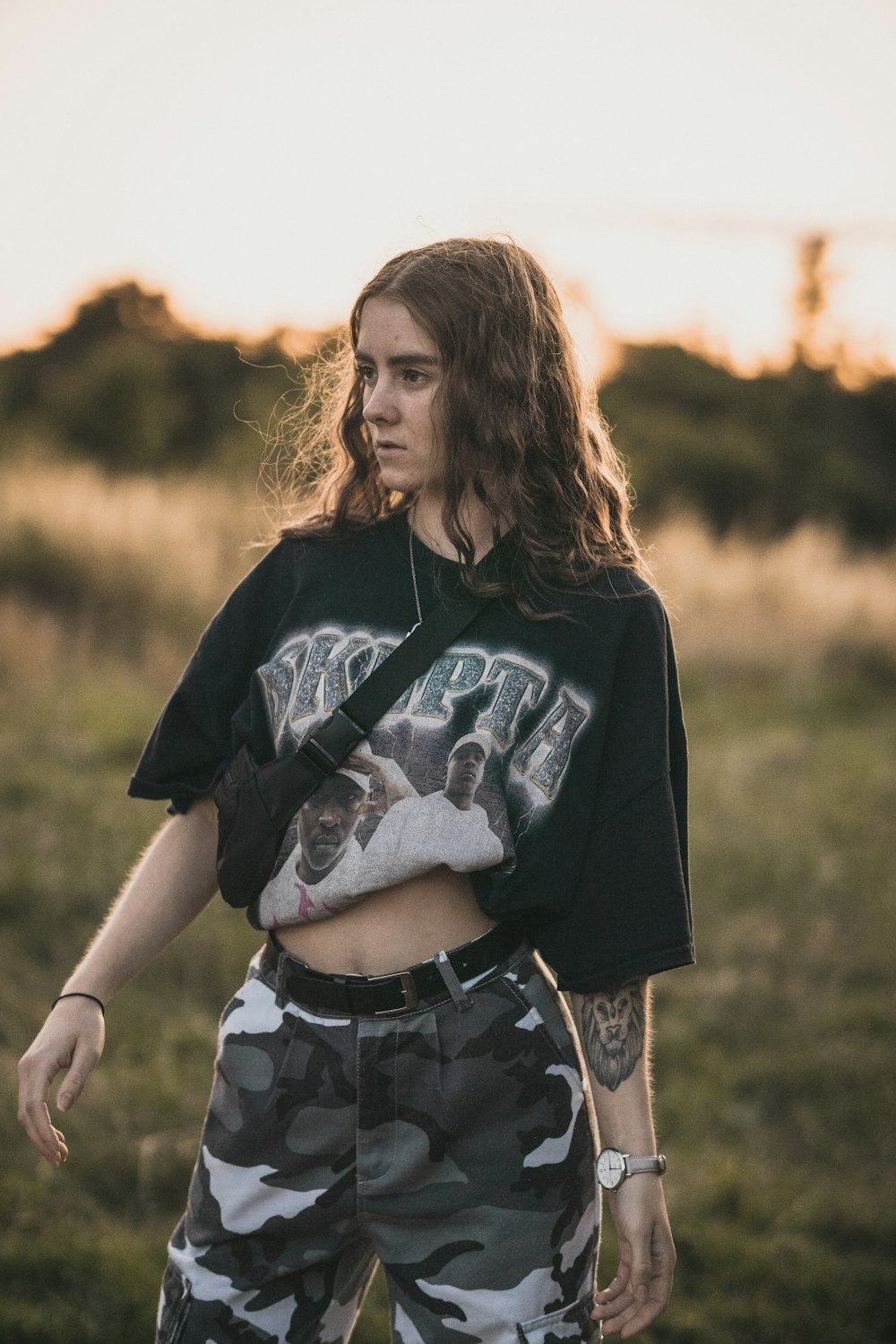 woman in a black and white top and camouflage pants