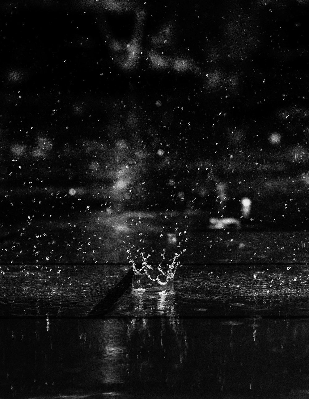 a black and white photo of a water splash