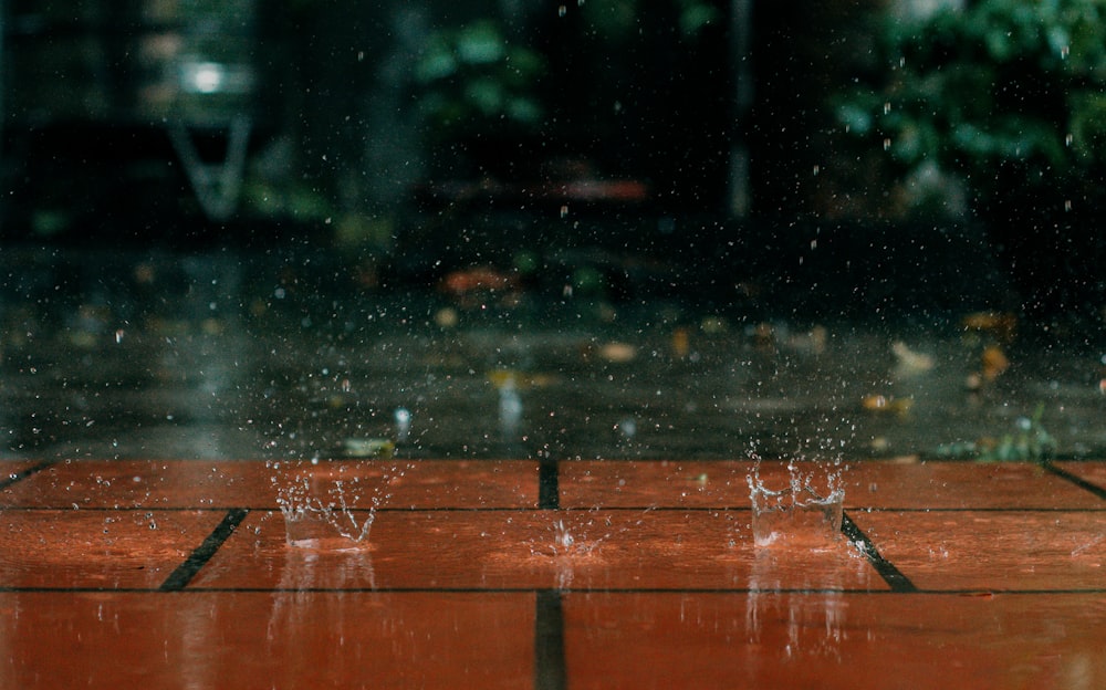 a red tile floor with water droplets on it