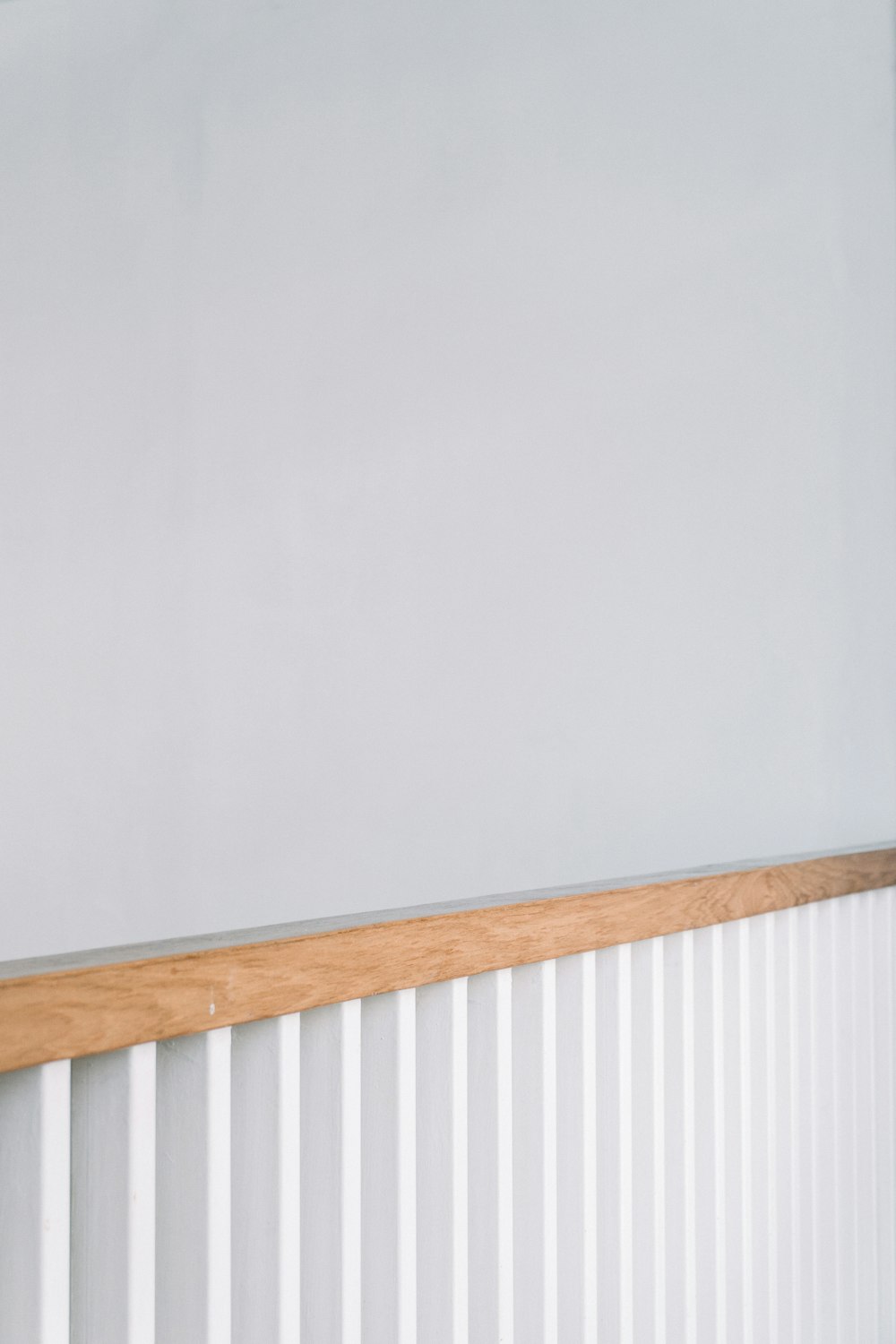 a cat sitting on top of a wooden shelf