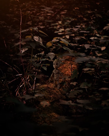 Animated character from an adventure game jumping over obstacles in a lush forest setting.