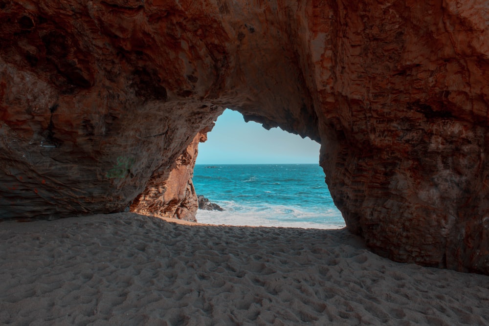 brown rock formation near body of water at daytime