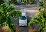 Scenic view of a rental car parked in front of a cozy Orlando vacation home.