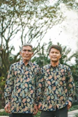 A casual outdoor scene with a couple wearing matching Telaviva tees featuring complementary custom designs.