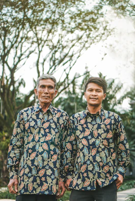 A casual outdoor scene with a couple wearing matching Telaviva tees featuring complementary custom designs.