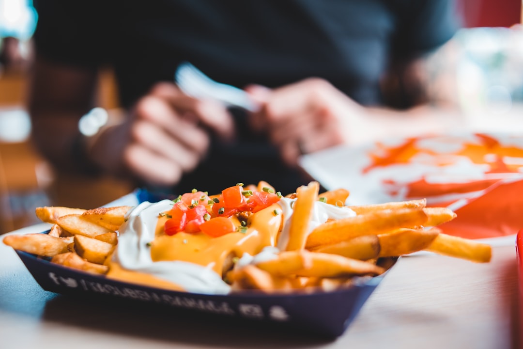 fries with sauce on disposable tray