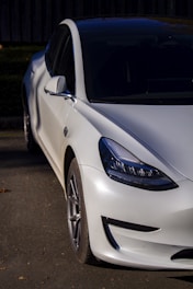 A sleek car with a glossy finish parked under natural light.