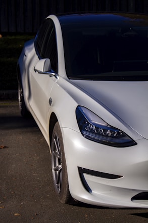 A sleek car with a glossy finish parked under natural light.