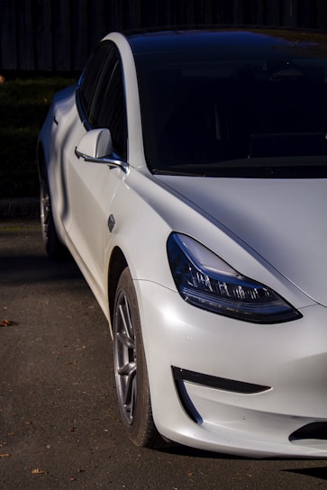 Front view of the sleek, polished vehicle parked under soft natural light highlighting its smooth curves.