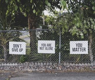 don't give up. You are not alone, you matter signage on metal fence