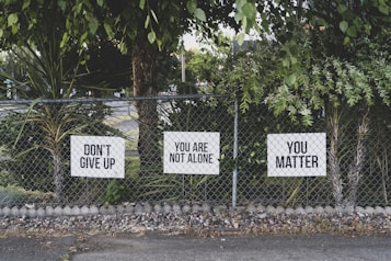 don't give up. You are not alone, you matter signage on metal fence