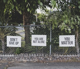 don't give up. You are not alone, you matter signage on metal fence