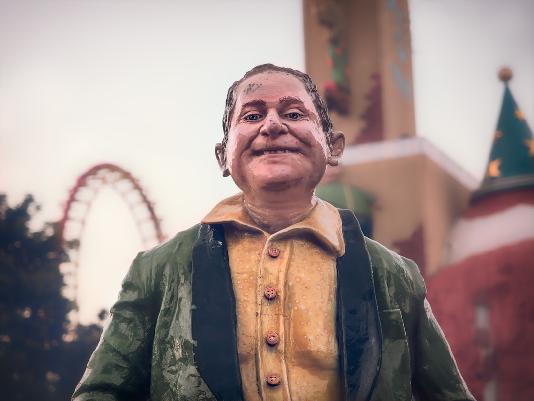 man wearing yellow button-up collared shirt statue