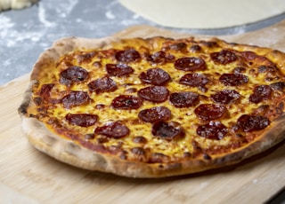 pepperoni pizza on a wooden tray