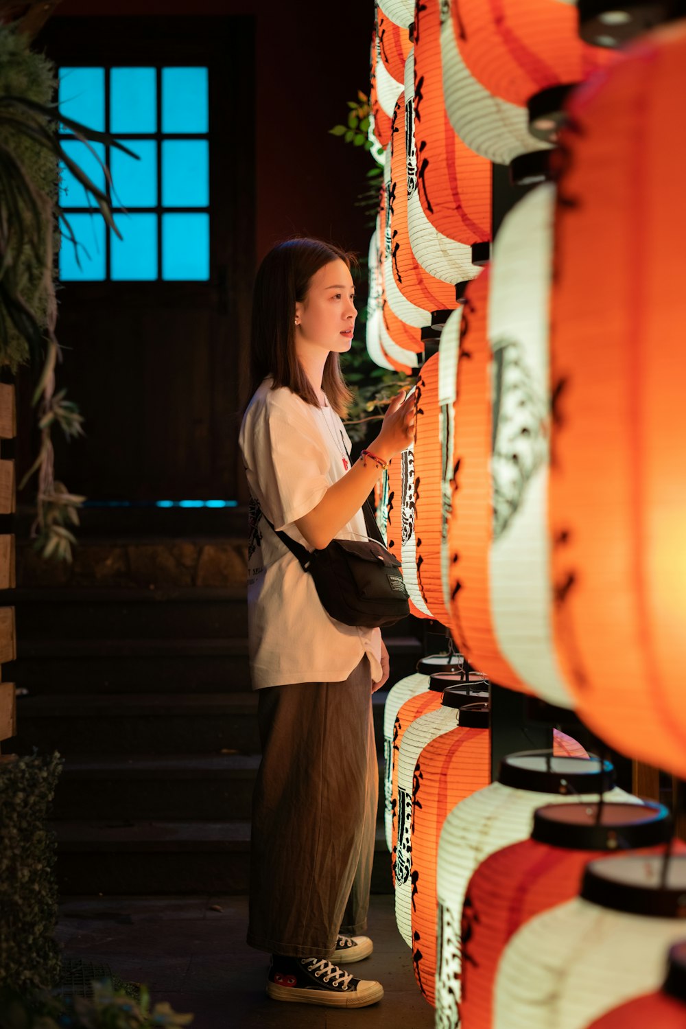 woman standing near lanterns