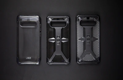 Close-up of a rugged phone case with reinforced corners next to a phone safely enclosed, showing durability in action.