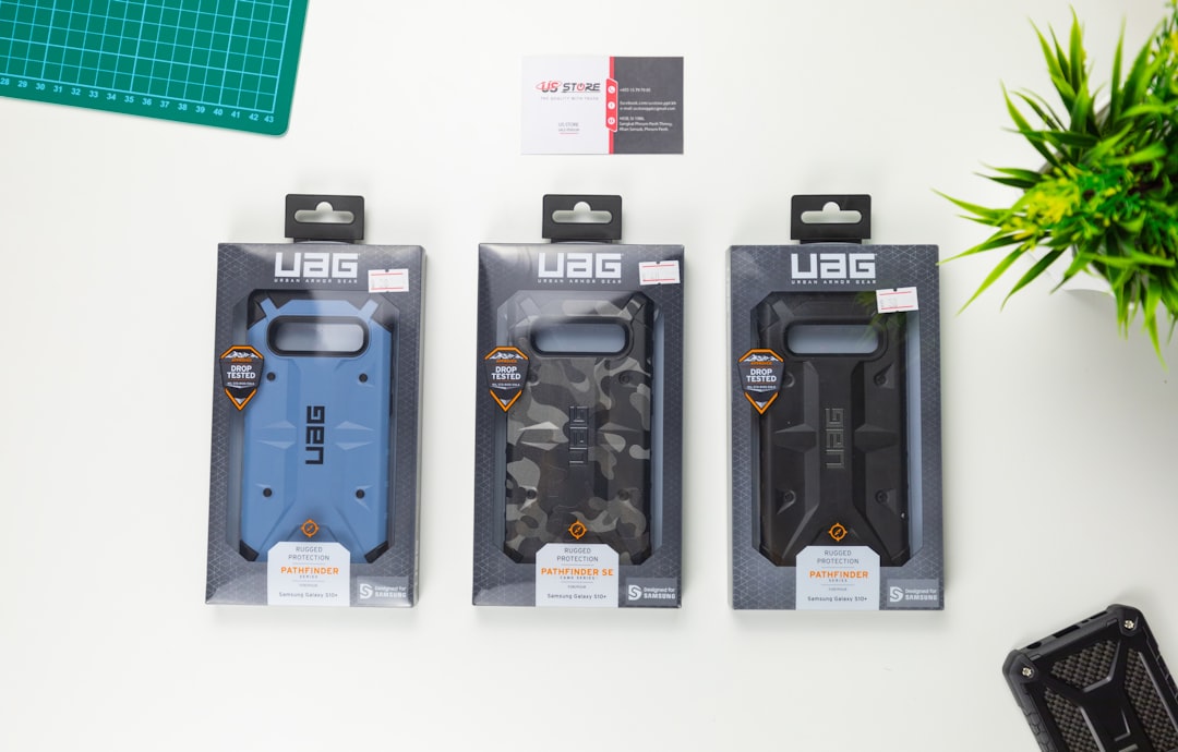 three assorted-color UAG phone case boxes