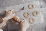 A cozy kitchen scene with hands preparing dough using premium baking utensils.