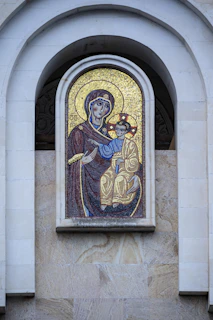 Close-up of a vibrant mosaic icon featuring intricate stone and glass pieces.