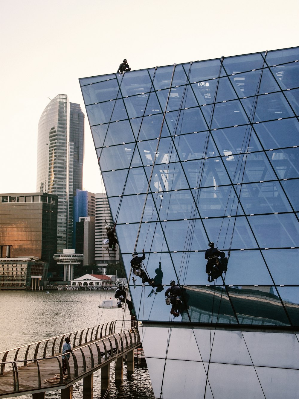 people cleaning glass building