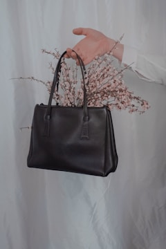 flowers in brown leather handbag