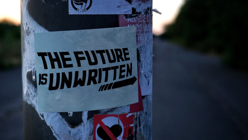 white and black the future is unwritten sticker close-up photography