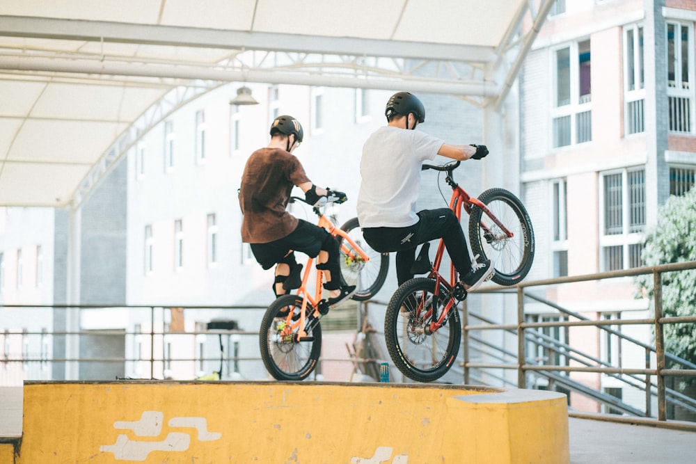 two men riding bicycles