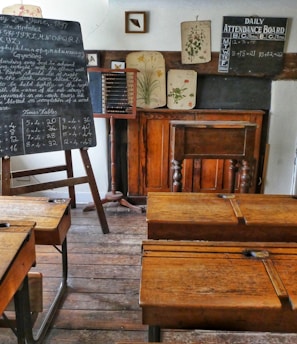 four brown desks inside room