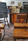 four brown desks inside room