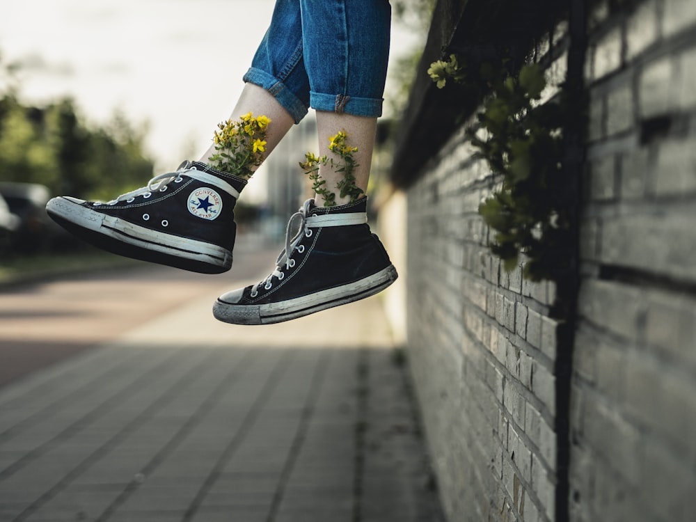 pair of black-and-white Converse All Star high-top sneakers