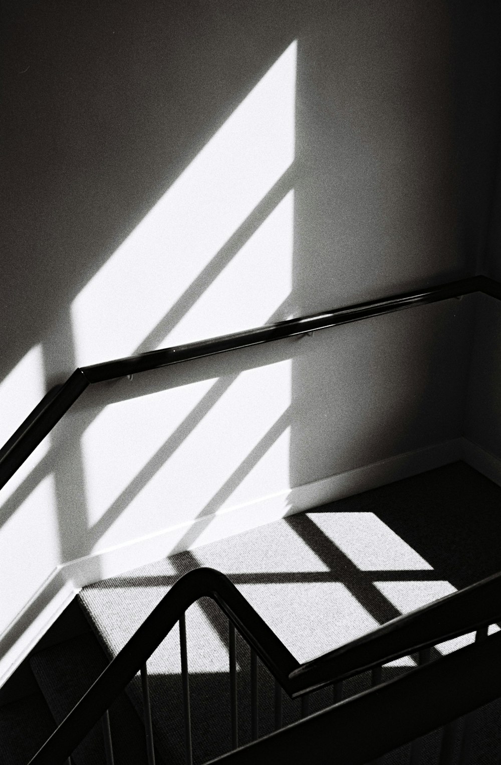 grayscale photo of stairs and handrail
