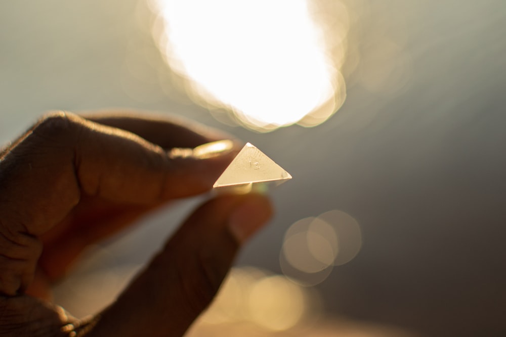 person holding triangular accessory