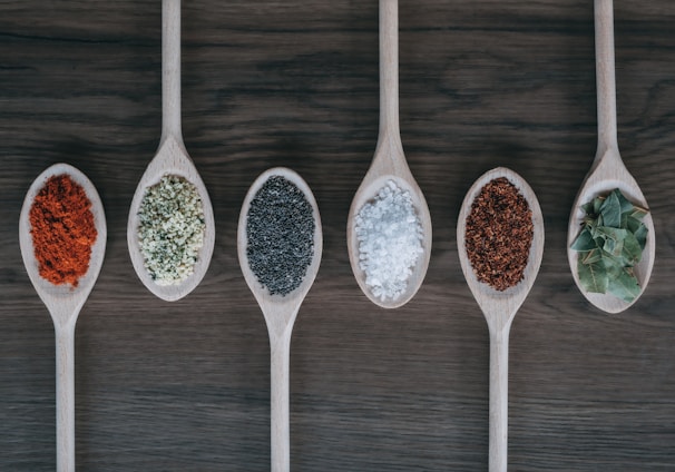 assorted-color spoons with spices