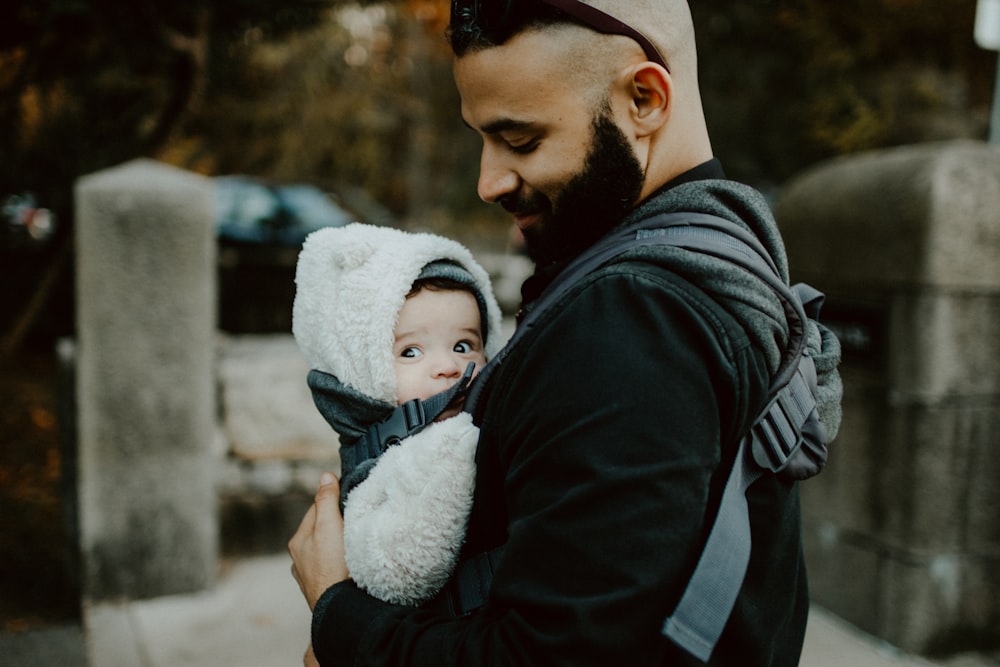 man carrying baby