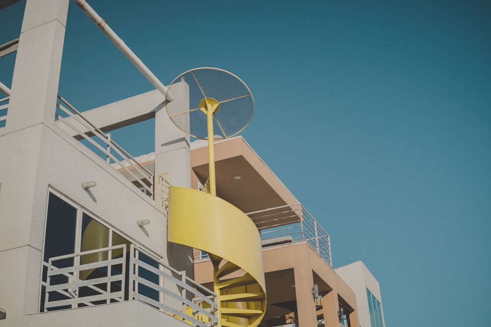 yellow spiral stairs on side of building