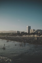 A panoramic shot of Busan's Haeundae Beach crowded with visitors on a sunny day.