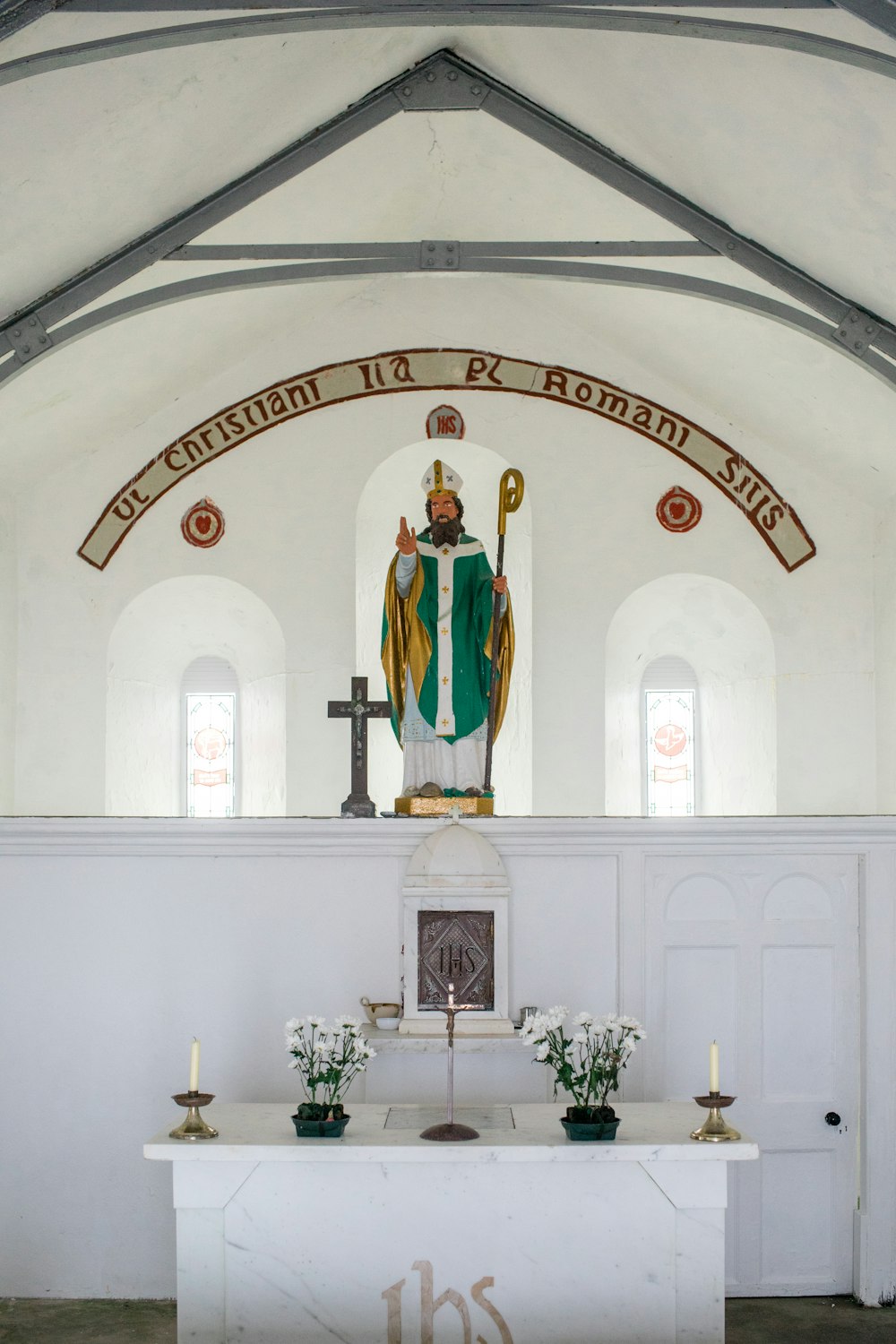 a church with a statue of a priest in the center