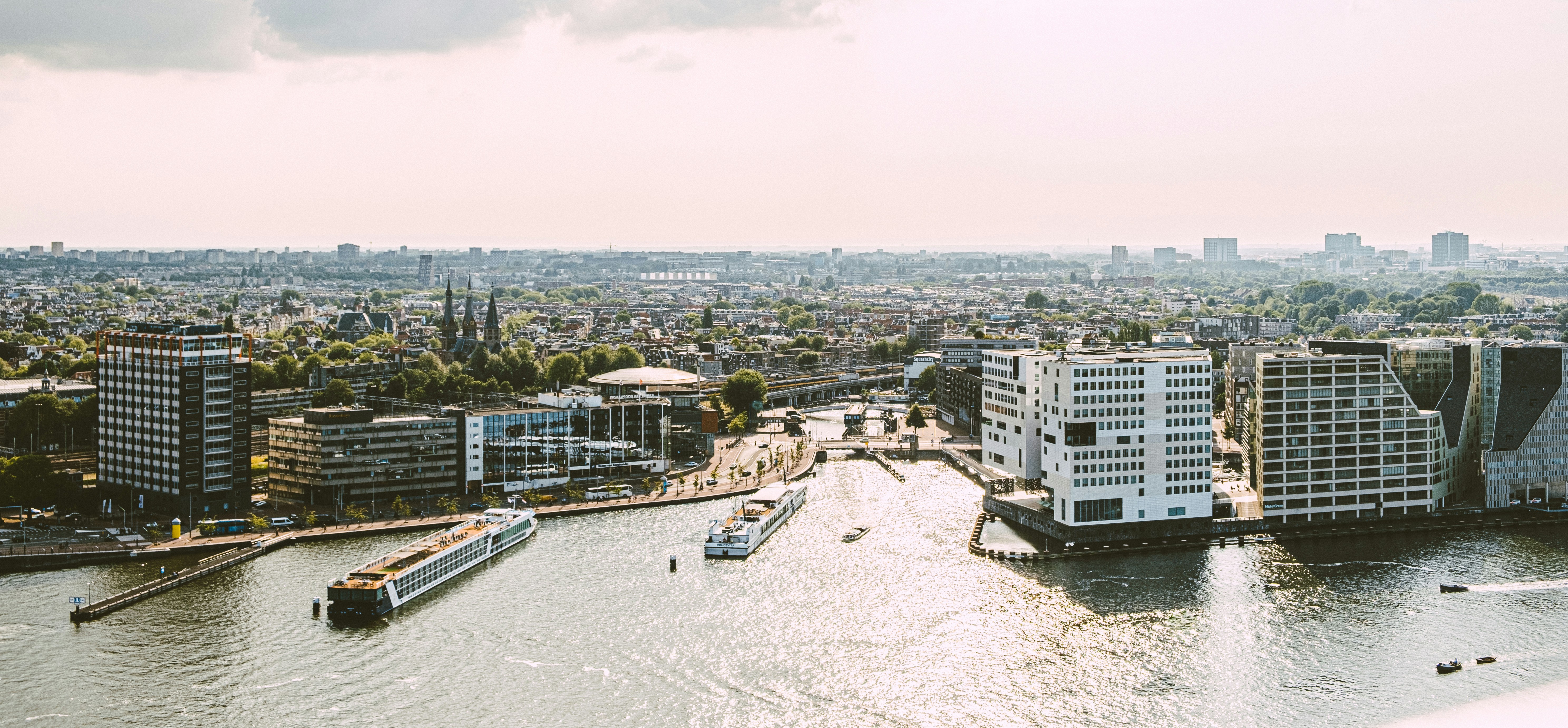 a river running through a city next to tall buildings