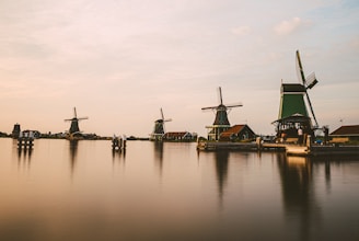 a group of windmills sitting on top of a lake