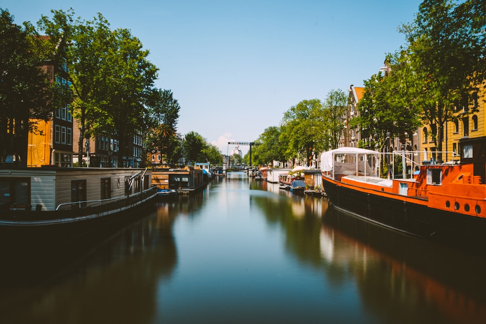 a canal with boats and houses on both sides