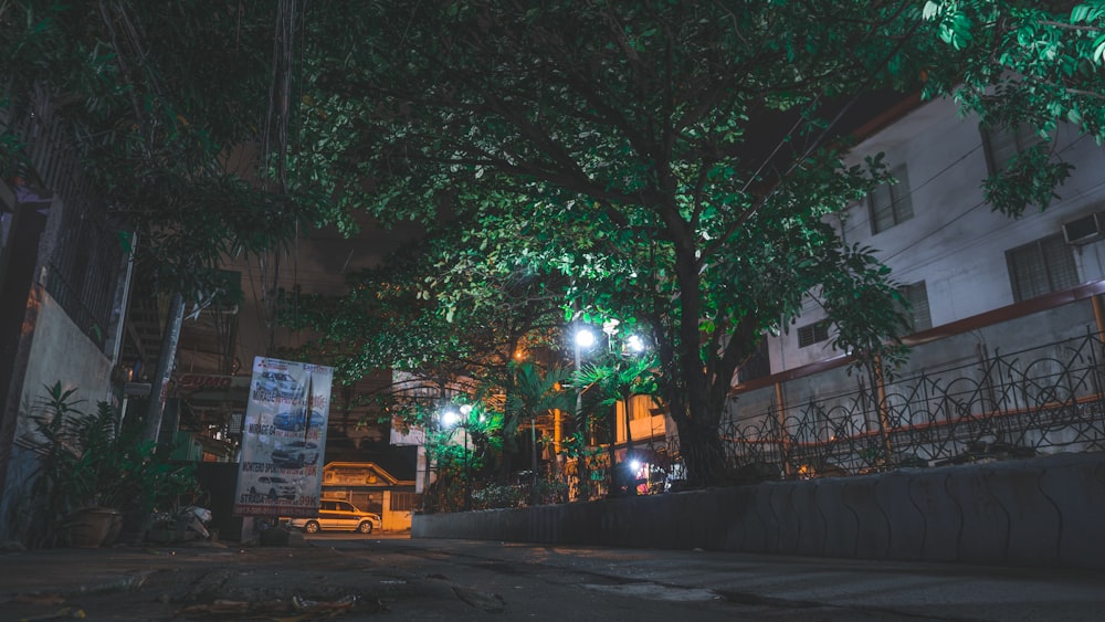 a car parked on the side of a street at night