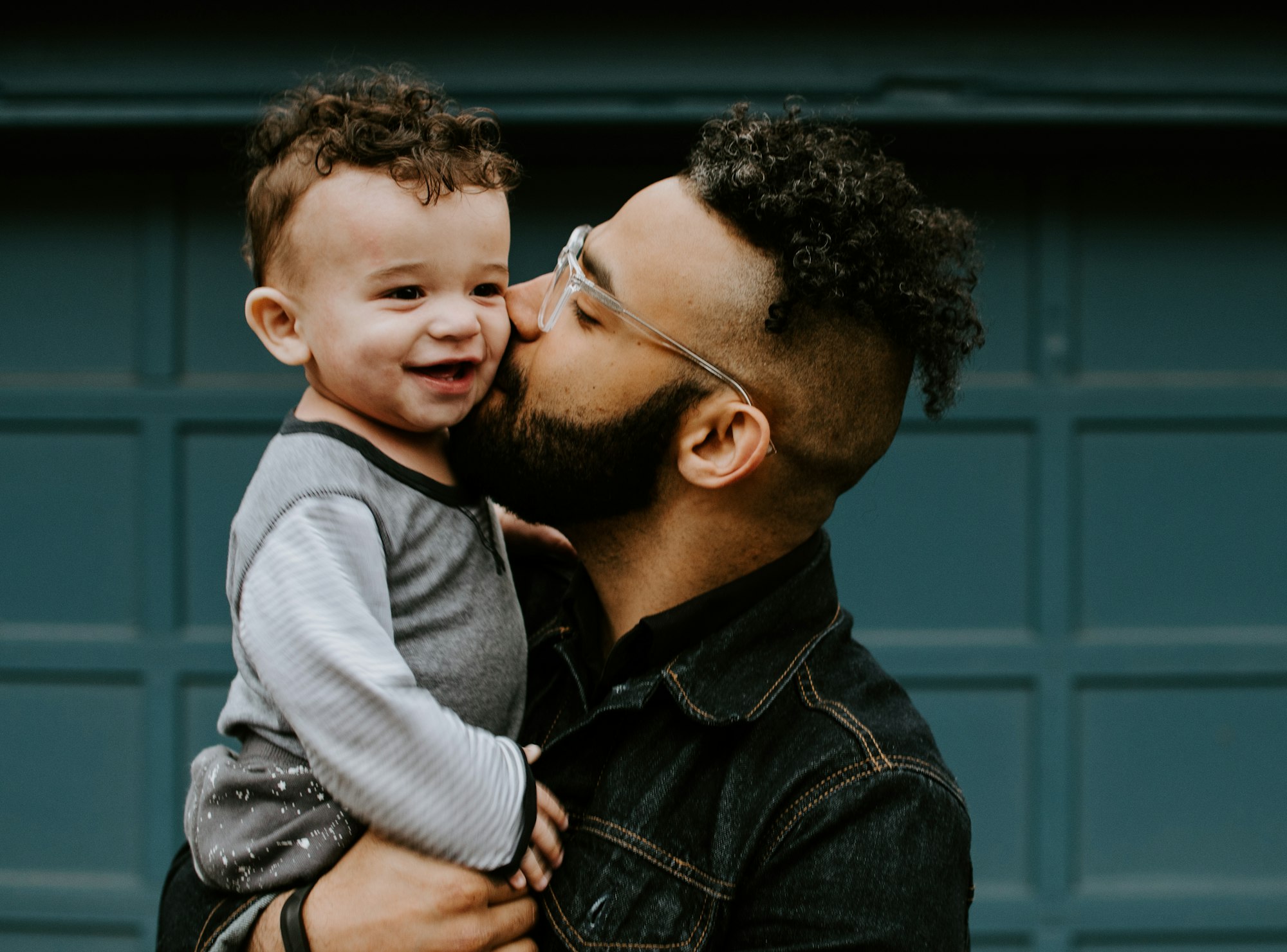 Father holding his baby boy with matching haircut