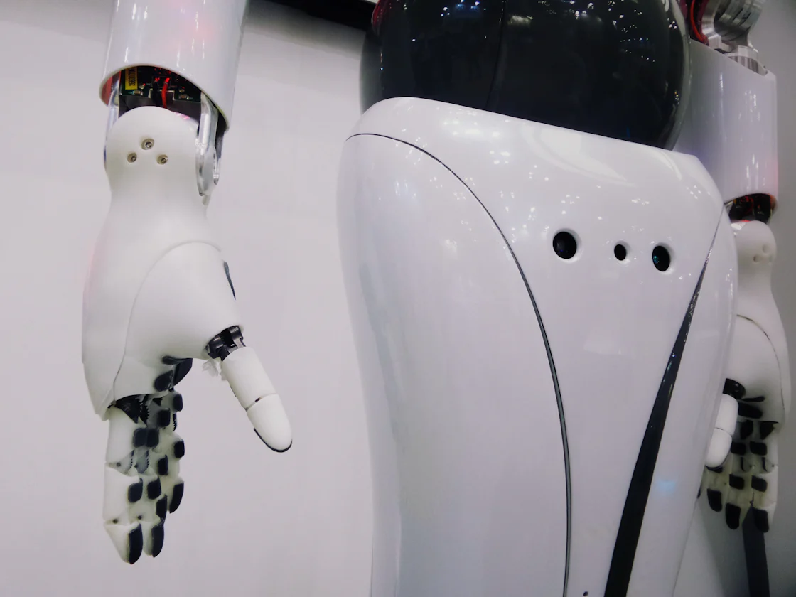 A white and black humanoid robot against a dark background, representing the autonomous AI agents that Meta is betting billions to build.