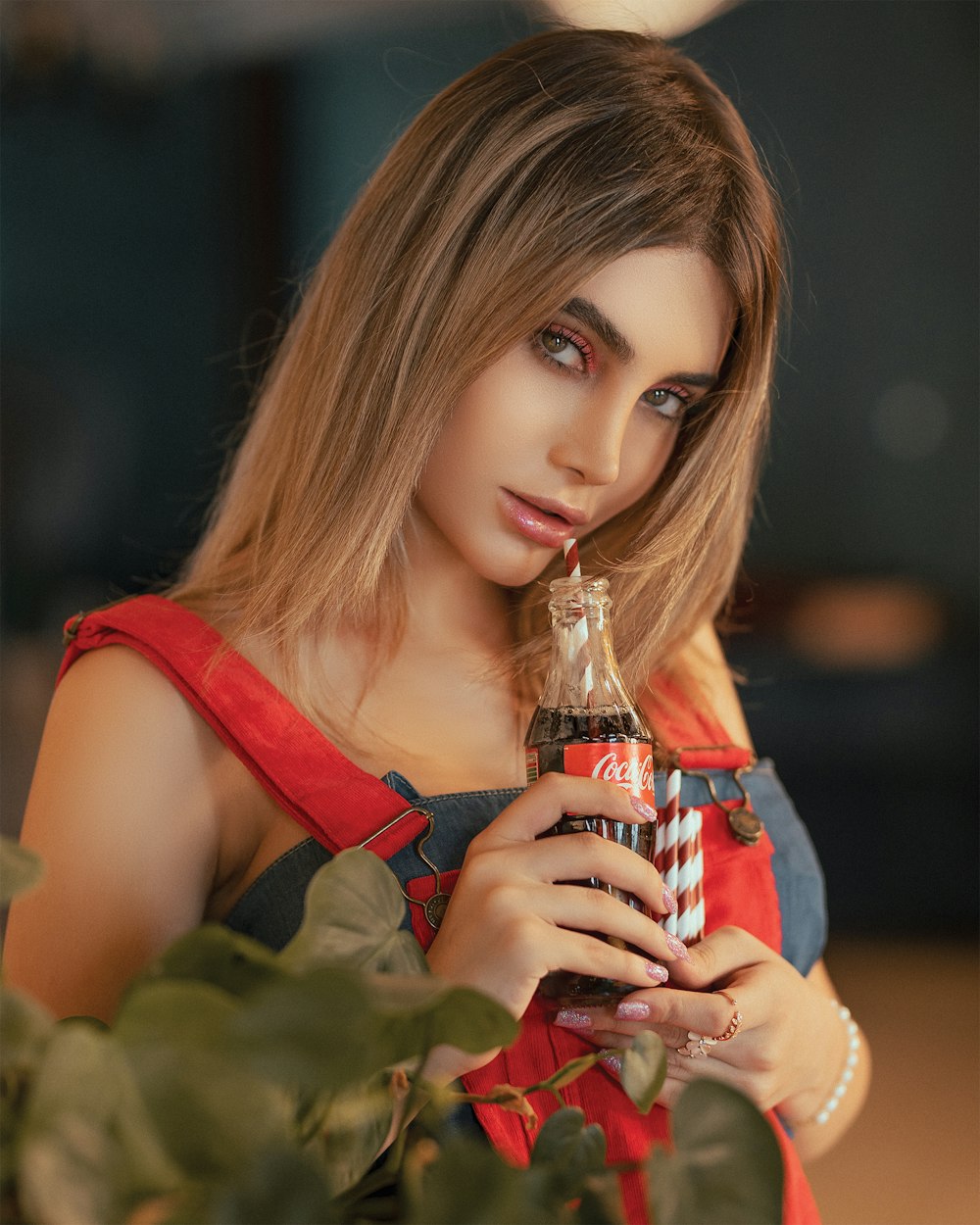 woman holding Coca-Cola soda bottle