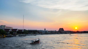 A serene boat ride along the Tonle Sap lake at sunset.