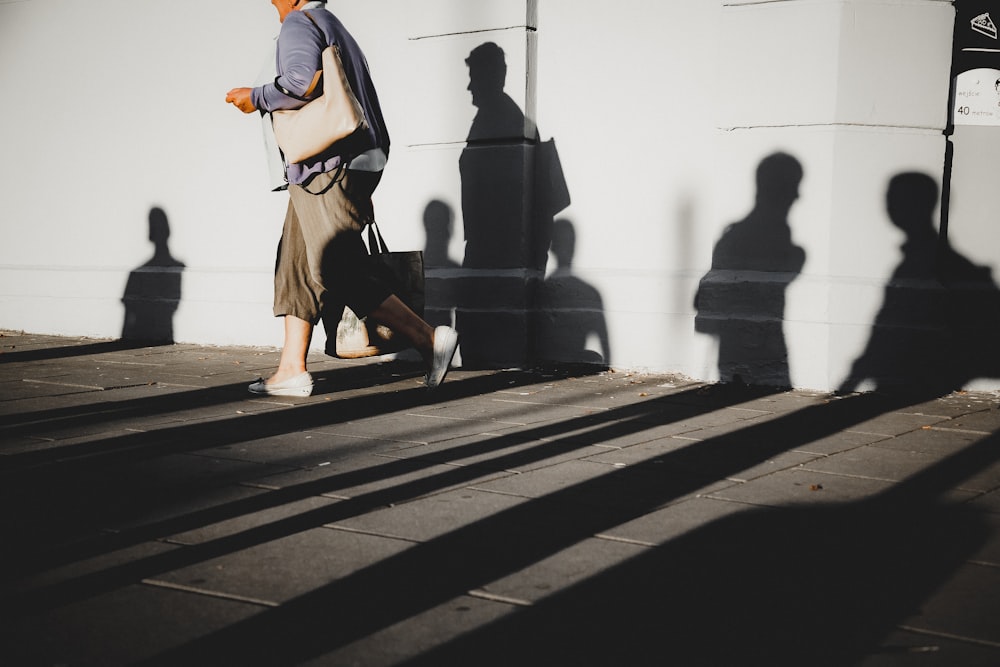 person walking beside wall